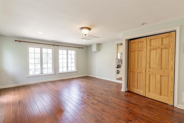 interior space with baseboards and dark wood-style flooring