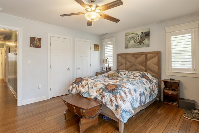 bedroom featuring baseboards, wood-type flooring, and a ceiling fan