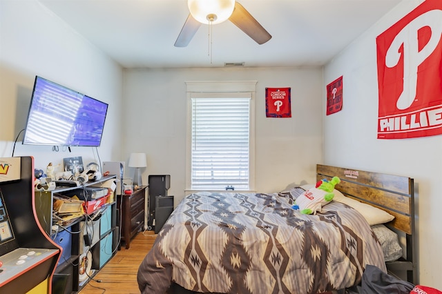bedroom with a ceiling fan, visible vents, and light wood-style flooring