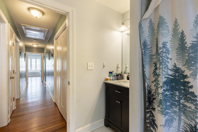 full bathroom with vanity, baseboards, and wood finished floors