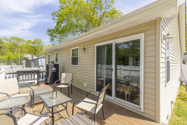deck with fence and a trampoline