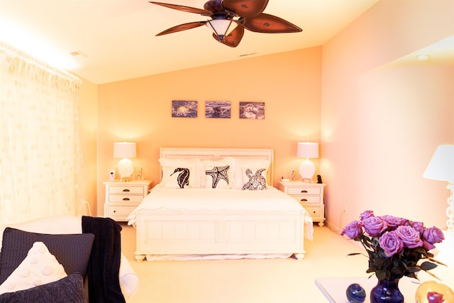 bedroom with lofted ceiling, ceiling fan, and light carpet