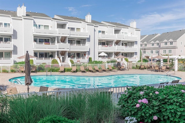 pool featuring fence and a residential view