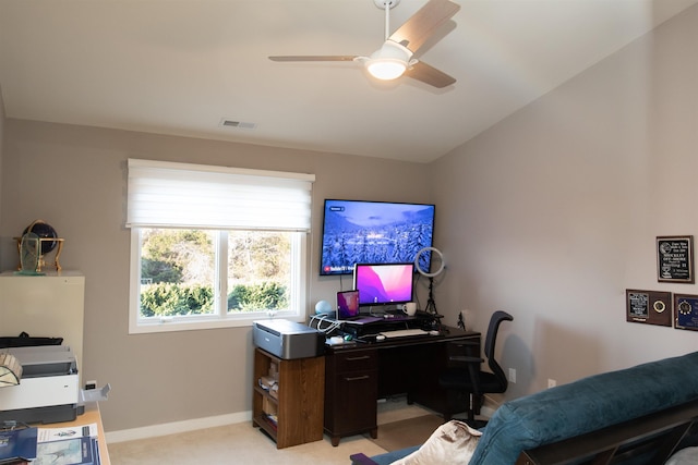 office space featuring vaulted ceiling, light carpet, a ceiling fan, and baseboards