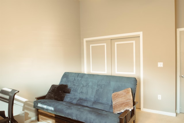 sitting room featuring baseboards and light colored carpet