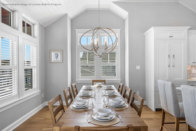 288 86th St, Stone Harbor, NJ 08247 - dining area featuring a chandelier, vaulted ceiling, and light wood finished floors