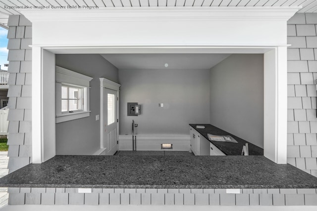 288 86th St, Stone Harbor, NJ 08247 - interior space with dark stone counters and crown molding