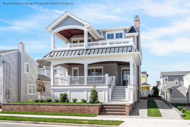 288 86th St, Stone Harbor, NJ 08247 - view of front of home featuring a balcony, a standing seam roof, covered porch, stairway, and a metal roof