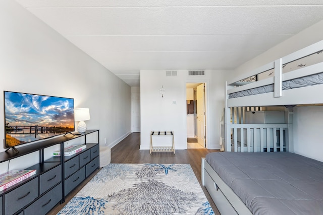 bedroom with wood finished floors and baseboards