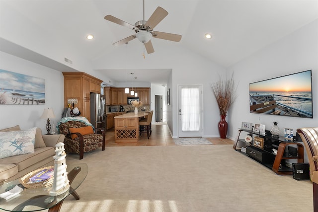 carpeted living room featuring high vaulted ceiling and ceiling fan