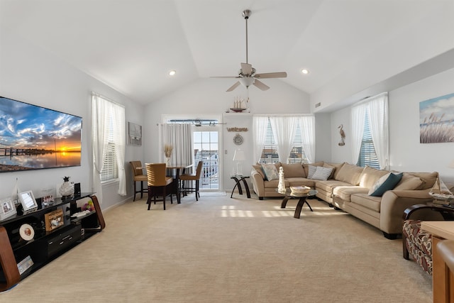 living room with ceiling fan, light carpet, and high vaulted ceiling