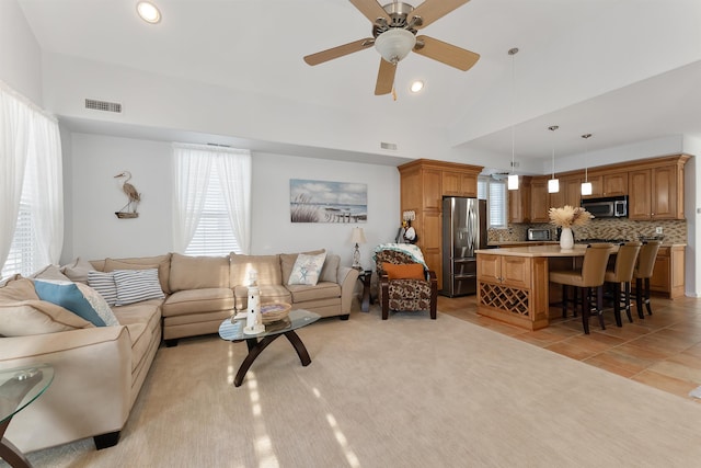 tiled living room featuring ceiling fan