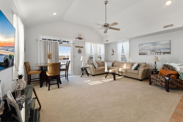 living room featuring ceiling fan and vaulted ceiling