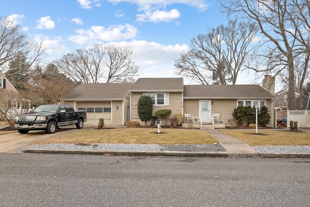 ranch-style home with a garage and a front yard