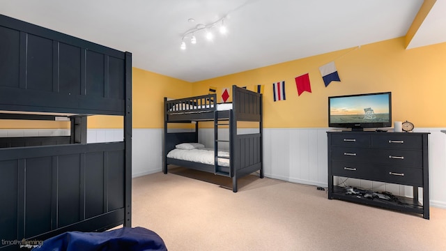 bedroom with carpet and wainscoting