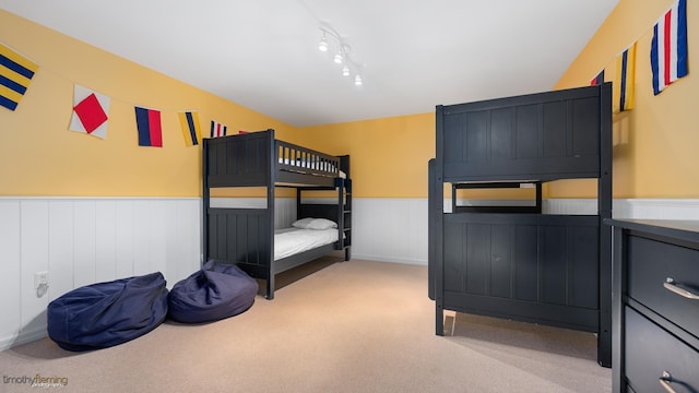 bedroom featuring wainscoting and carpet flooring