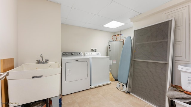 laundry room featuring laundry area, light tile patterned floors, washer and clothes dryer, water heater, and a sink