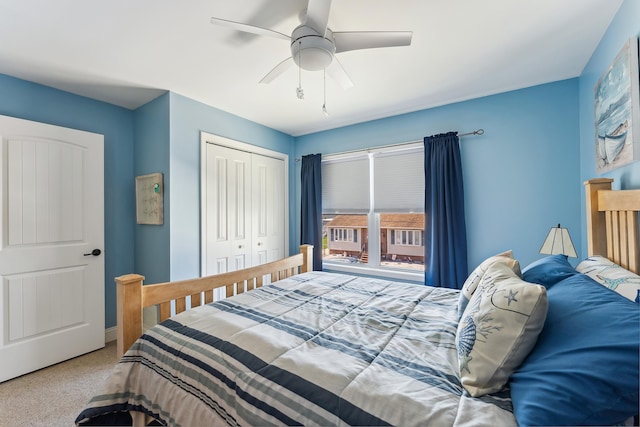 carpeted bedroom featuring a closet, baseboards, and ceiling fan