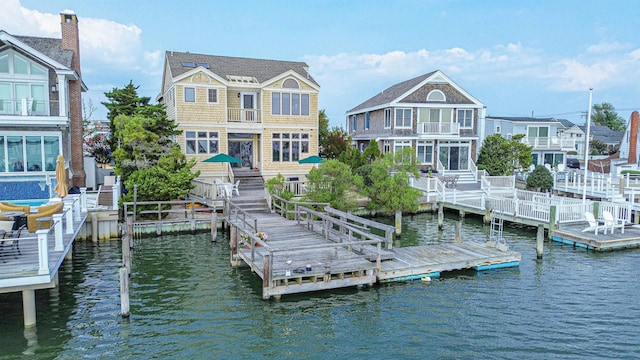 rear view of house featuring a water view