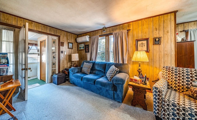 living room featuring a wall mounted air conditioner, carpet floors, wooden walls, and a textured ceiling