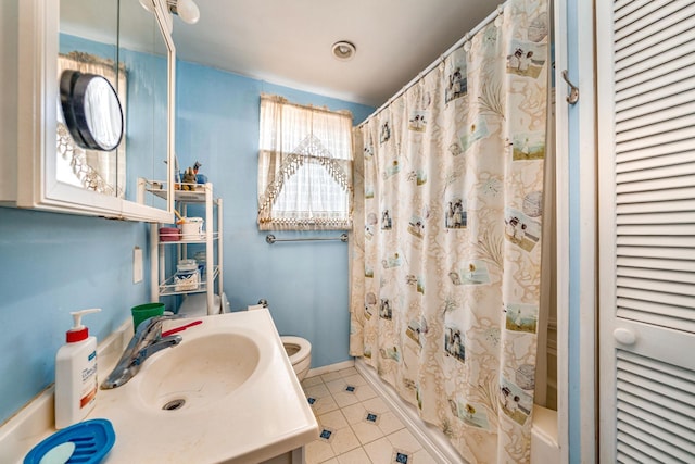 bathroom featuring tile patterned flooring, vanity, and toilet