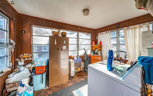 interior space with wooden walls and independent washer and dryer