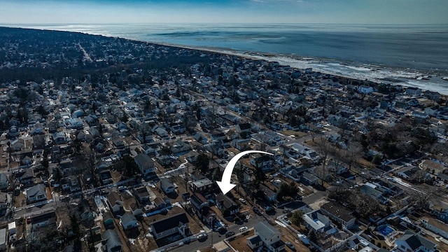 drone / aerial view featuring a water view and a beach view