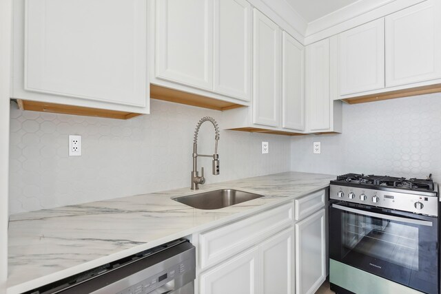233 E Juniper Ave Unit A, Wildwood, NJ 08260 - kitchen featuring gas stove, a sink, dishwasher, white cabinets, and decorative backsplash