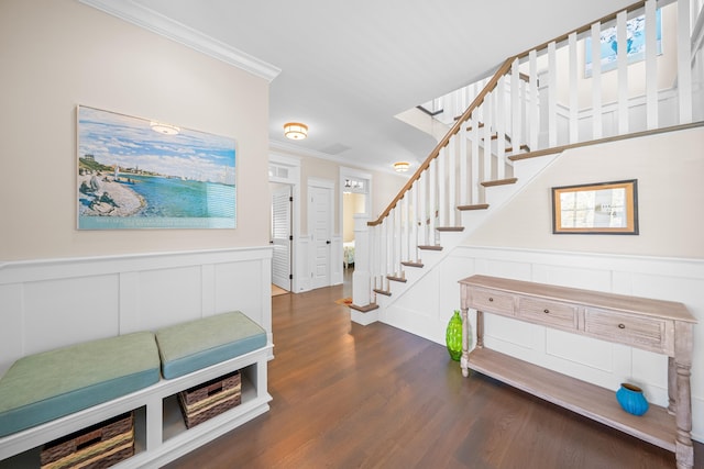 entryway with ornamental molding and dark hardwood / wood-style flooring