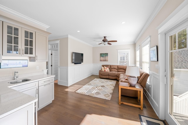 living room with ornamental molding, sink, ceiling fan, and dark hardwood / wood-style floors