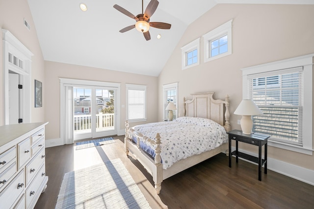 bedroom with multiple windows, access to exterior, dark wood-type flooring, and high vaulted ceiling