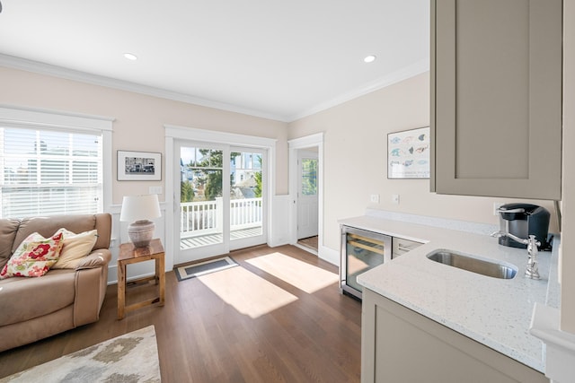 interior space featuring a healthy amount of sunlight, ornamental molding, gray cabinets, and light stone countertops