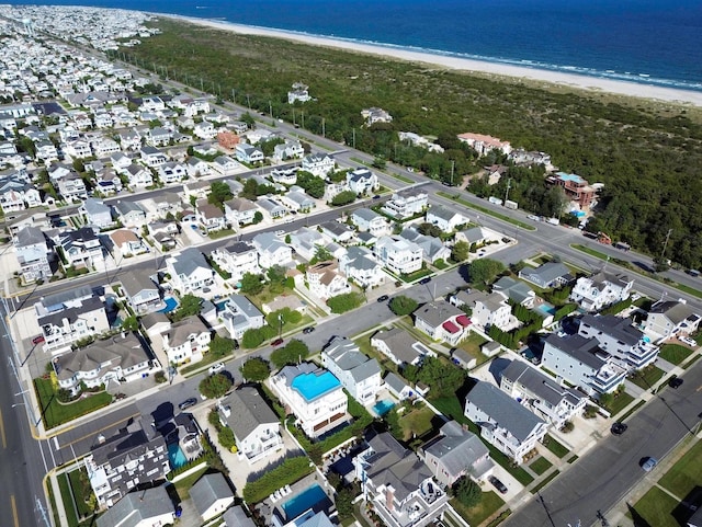 birds eye view of property featuring a view of the beach and a water view