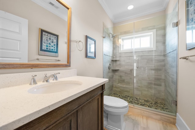 bathroom with crown molding, walk in shower, vanity, and toilet