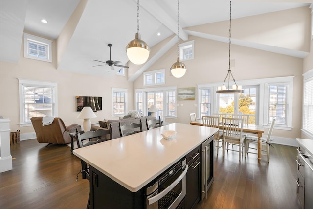 kitchen with dark hardwood / wood-style floors, a center island, hanging light fixtures, and oven