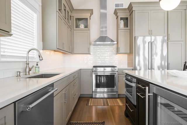 kitchen with sink, wine cooler, dark hardwood / wood-style flooring, stainless steel appliances, and wall chimney exhaust hood