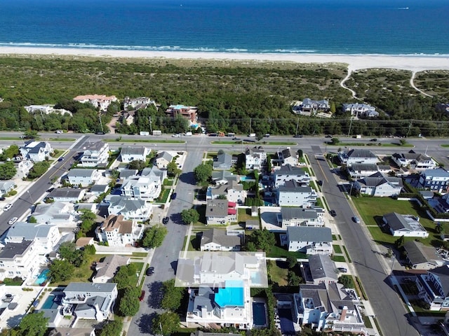 bird's eye view featuring a water view and a view of the beach