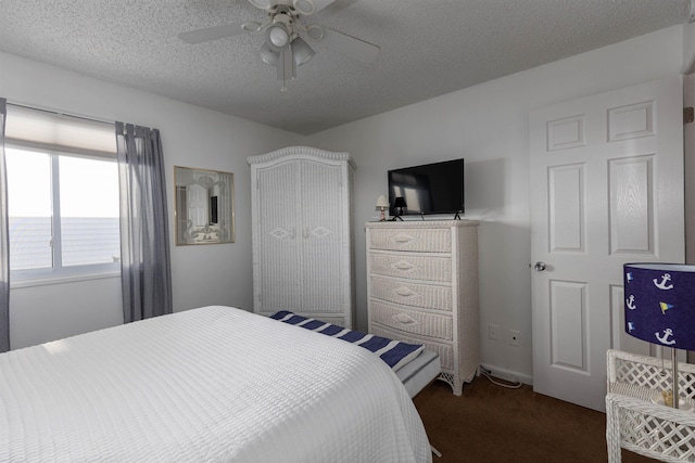 carpeted bedroom featuring ceiling fan and a textured ceiling