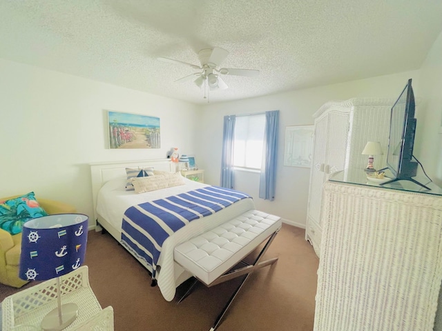 bedroom featuring ceiling fan, a textured ceiling, and dark colored carpet