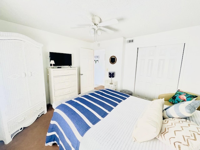 carpeted bedroom with ceiling fan and a closet