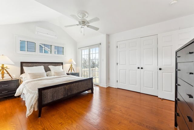 3005 Shore Dr, Cape May Beach, NJ 08251 - bedroom with a closet, a wall mounted air conditioner, a ceiling fan, lofted ceiling, and wood finished floors