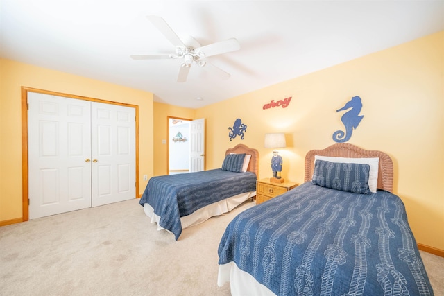 carpeted bedroom with ceiling fan and a closet