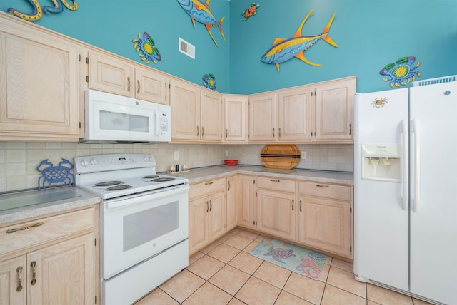 kitchen featuring light brown cabinets, a towering ceiling, light tile patterned flooring, white appliances, and decorative backsplash