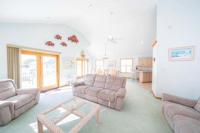 carpeted living room featuring high vaulted ceiling and ceiling fan