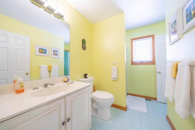 bathroom featuring tile patterned floors, vanity, and toilet