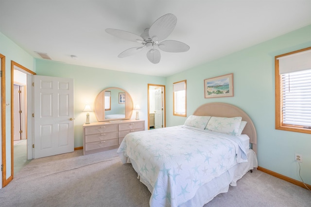 carpeted bedroom with ceiling fan and multiple windows