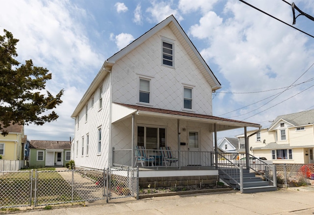 112 E Montgomery Ave, Wildwood, NJ 08260 - view of front facade with a gate, covered porch, and a fenced front yard