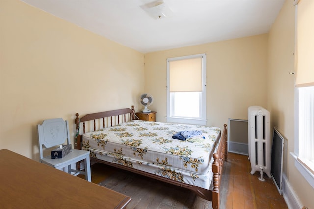 112 E Montgomery Ave, Wildwood, NJ 08260 - bedroom with wood-type flooring, radiator heating unit, and multiple windows