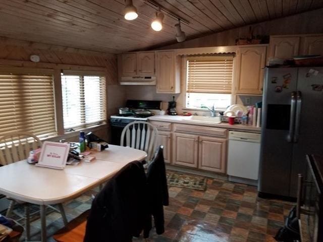 kitchen featuring under cabinet range hood, light countertops, stainless steel refrigerator with ice dispenser, dishwasher, and gas range oven