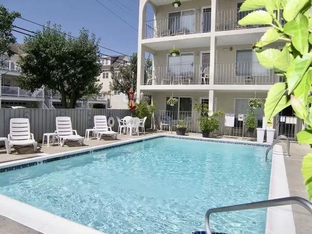 rear view of property featuring a community pool